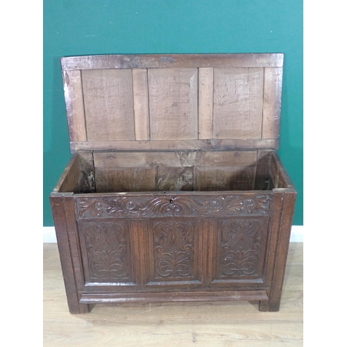 286 - A 17th Century oak Coffer with three panel sunken lid above leafage carved frieze and three carved p... 