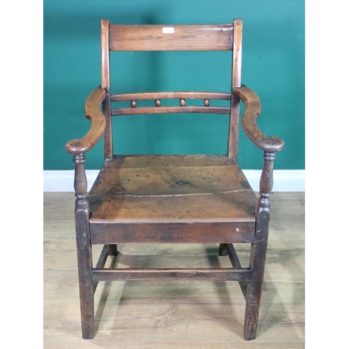 291 - An antique ash and elm Country Elbow Chair.