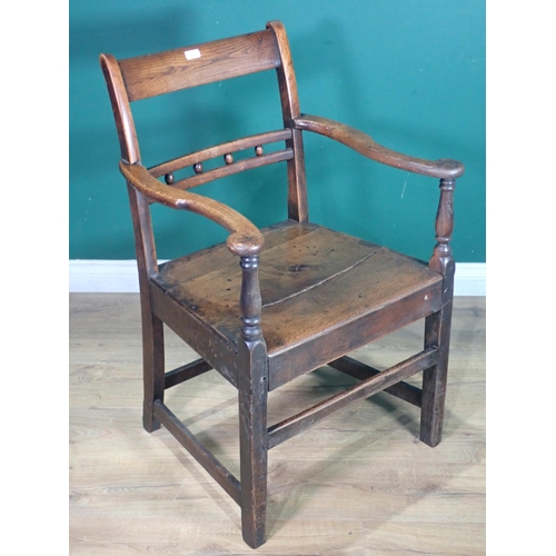 291 - An antique ash and elm Country Elbow Chair.