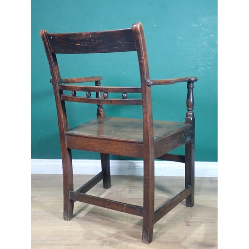 291 - An antique ash and elm Country Elbow Chair.