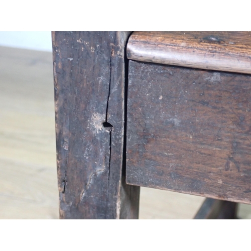 291 - An antique ash and elm Country Elbow Chair.