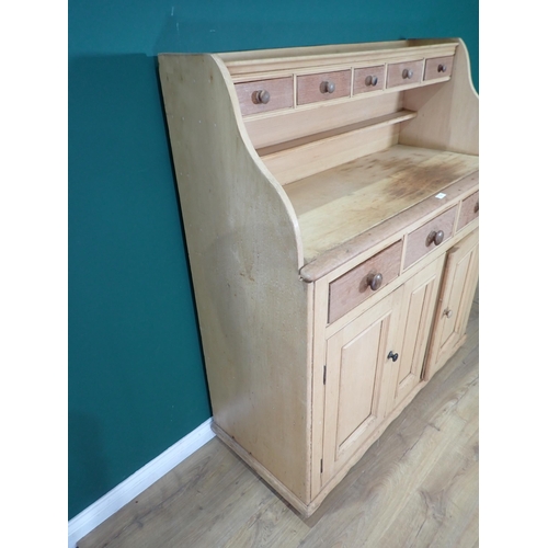 24 - A Victorian scrubbed pine Dresser with raised gallery fitted a bank of five oak drawers above three ... 