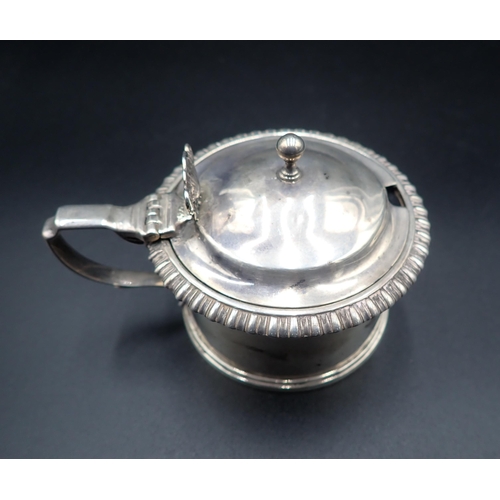 102 - A Georgian silver drum Mustard Pot, engraved crest, gadroon rim, ornate thumb piece, London hallmark... 