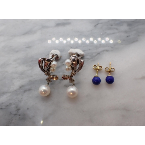 168 - A pair of Cultured Pearl Earrings each with ribbon effect plaque set two cultured pearls suspending ... 