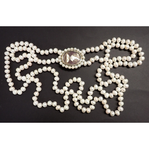 170 - A long two strand cultured freshwater pearl Necklace on oval white metal clasp formed from a mournin... 