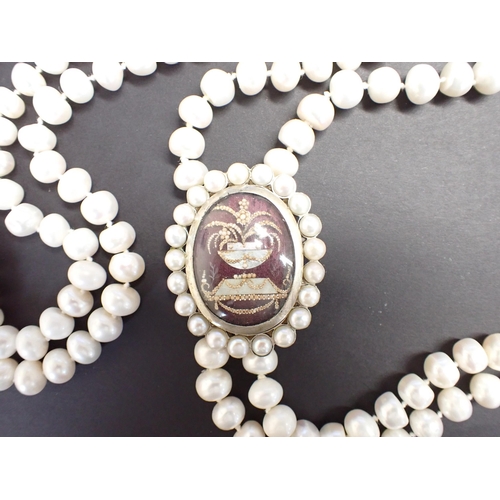 170 - A long two strand cultured freshwater pearl Necklace on oval white metal clasp formed from a mournin... 