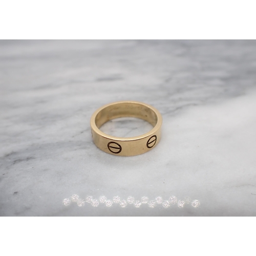 171 - A Cartier 'Love' Ring the polished 18ct gold band with screwhead motifs, ring size O, signed Cartier... 