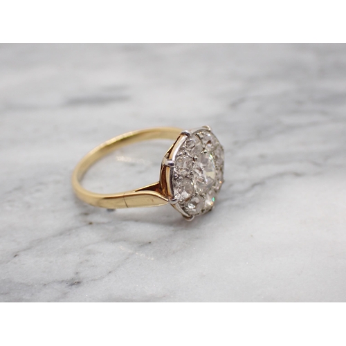 173 - A Diamond Cluster Ring pavé-set old-cut stone within frame of eight smaller stones, ring size K 1/2