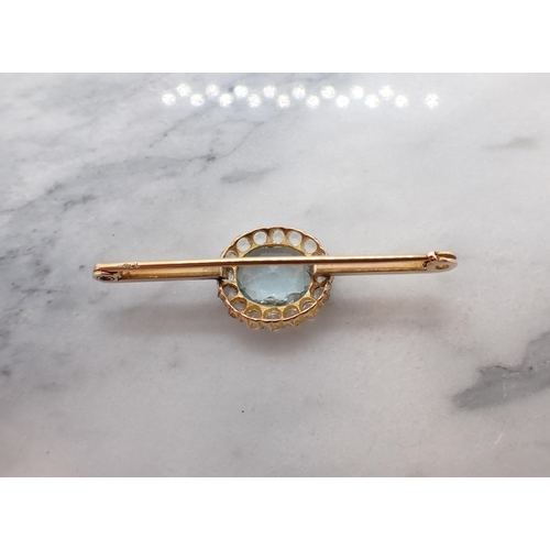 184 - An Aquamarine Cluster Bar brooch claw-set oval-cut aquamarine within a frame of white stones set on ... 