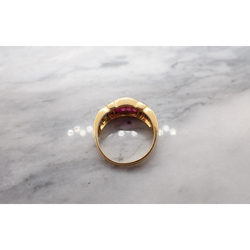 185 - A Ruby, Diamond and Sapphire Ring the wide band channel-set three rows of calibré-cut rubies between... 