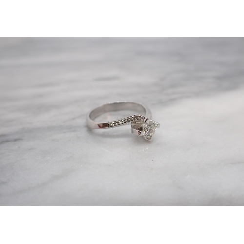 190 - A contemporary Diamond single stone Ring claw-set brilliant-cut stone in twist setting, rows of smal... 