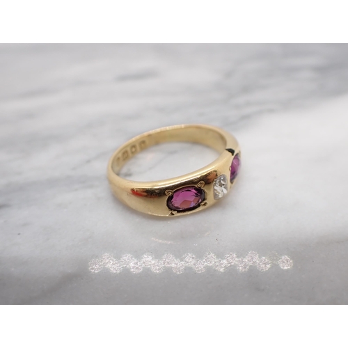 192 - A Diamond and Almondine Garnet three stone Ring gypsy-set old-cut diamond between two oval-cut garne... 