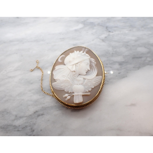 193 - A carved shell Cameo Brooch of the goddess Nyx, veiled and crowned with a wreath of poppies above an... 