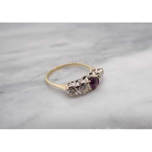 202 - A five stone Ring claw-set round purple stone, probably garnet, between four brilliant-cut diamonds ... 