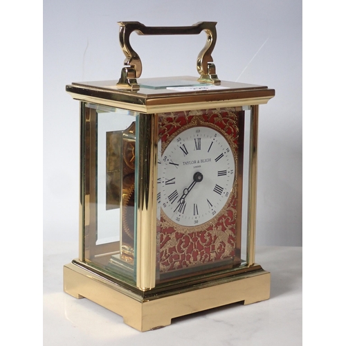 223 - A brass cased Carriage Clock by Taylor & Bligh, London, the circular dial surrounded by filligree ty... 