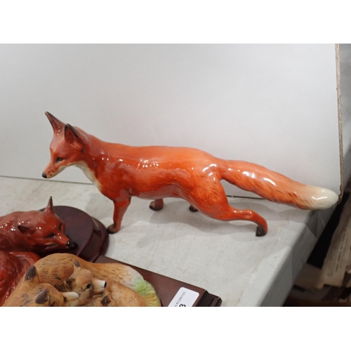 253 - A quantity of Figures of Foxes and Kingfishers and Dogs including two by Beswick