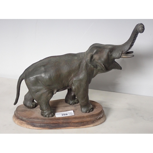 269 - A spelter model of an elephant on oval wooden base, 9in and a pair of wooden Dumbbells