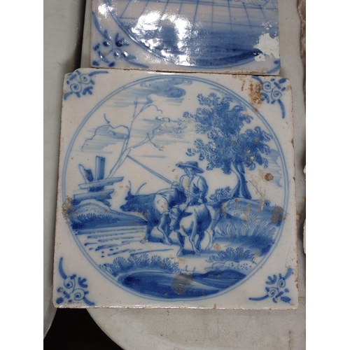 286 - A Box of Tiles including some Delft, decorated with country scenes and a quantity of diamond shaped ... 