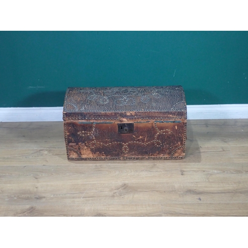 310 - A 19th Century leather covered dome topped Trunk with studwork decoration and blue lined interior be... 