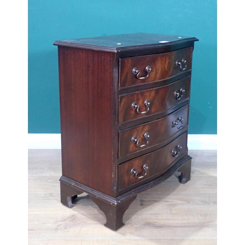 38 - A reproduction mahogany veneered serpentine Chest of four long drawers mounted on ogee bracket feet ... 