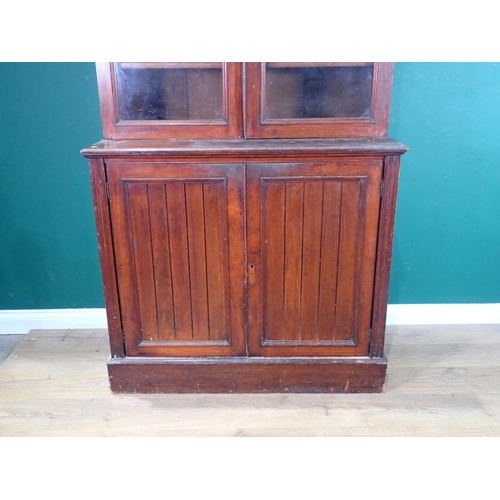 388 - A mahogany Bookcase the glazed top above a pair of panelled doors on plinth base, 7ft 7