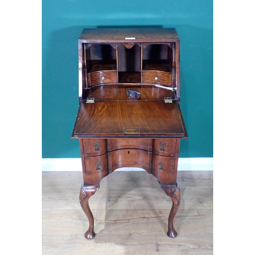 47 - A Queen Anne style walnut veneered Bureau fitted three concave drawers mounted on carved cabriole su... 