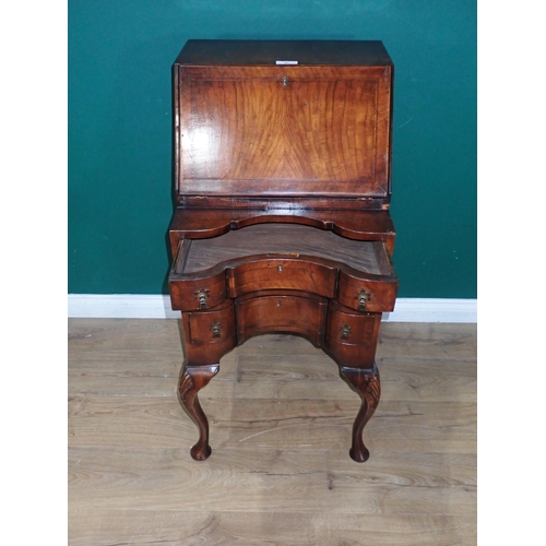 47 - A Queen Anne style walnut veneered Bureau fitted three concave drawers mounted on carved cabriole su... 