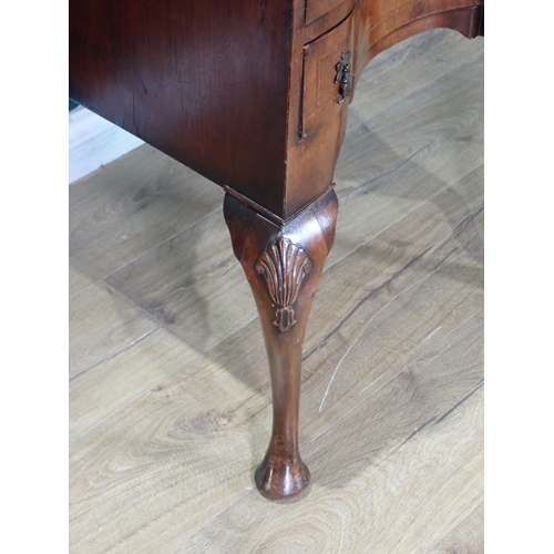 47 - A Queen Anne style walnut veneered Bureau fitted three concave drawers mounted on carved cabriole su... 