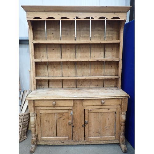 479 - A 19th Century pine Irish Dresser and Rack fitted two frieze drawers above pair of cupboard doors to... 