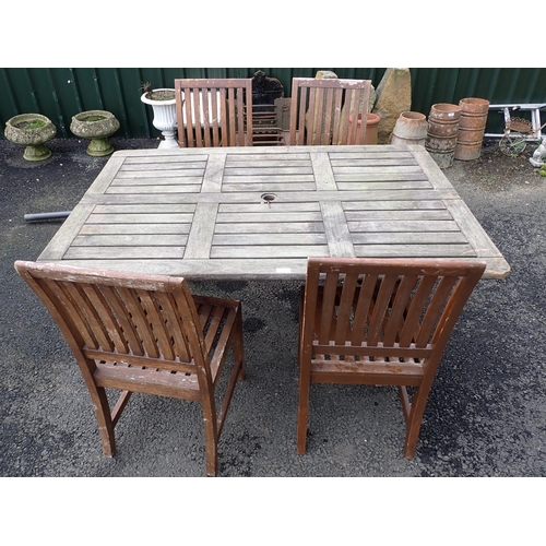 597 - A wooden Garden Table and Parasol and a set of four Westminster Teak Garden Chairs.