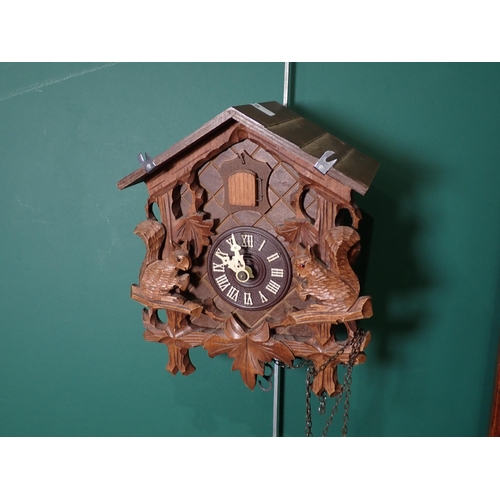 295 - A mahogany stick case barometer by Thos Wright, a cuckoo clock, two bags of floral material