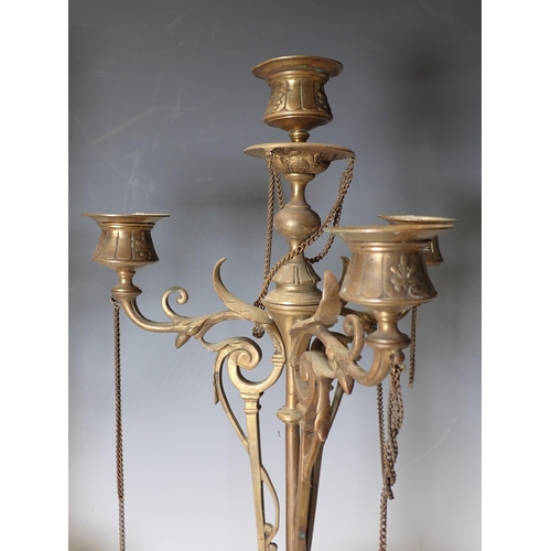 296 - A pair of brass four sconce Candelabra with leafage and scroll designs on circular slate bases, 19