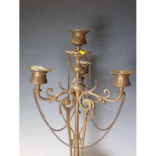 296 - A pair of brass four sconce Candelabra with leafage and scroll designs on circular slate bases, 19