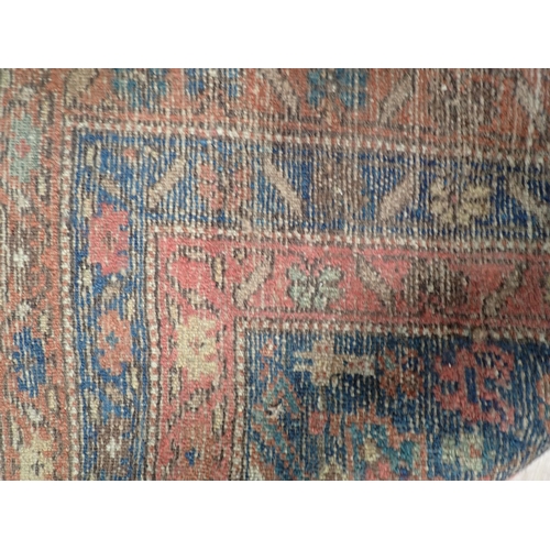 10 - An old Persian woollen Rug with stylised flower design on blue ground within multiple borders 6ft 2i... 