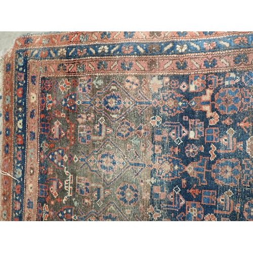 10 - An old Persian woollen Rug with stylised flower design on blue ground within multiple borders 6ft 2i... 