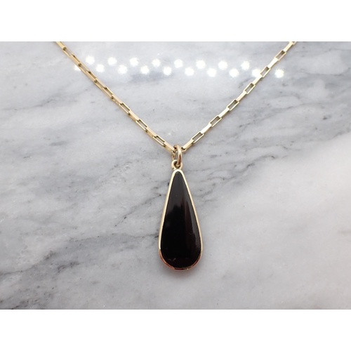 157 - A black Onyx drop shaped Pendant in 9ct gold mount on 9ct gold rectangular link chain, approx 4.00gm... 