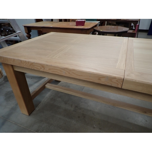 16 - A large modern oak Dining Table on square supports labelled Corndell Furniture 7' 3