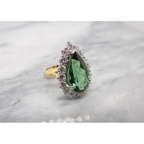 172 - A Green Tourmaline and Diamond Cluster Ring claw-set large pear-cut tourmaline within a frame of six... 