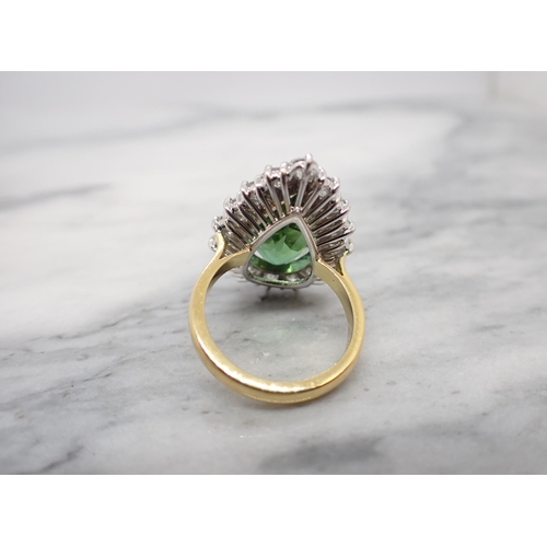 172 - A Green Tourmaline and Diamond Cluster Ring claw-set large pear-cut tourmaline within a frame of six... 