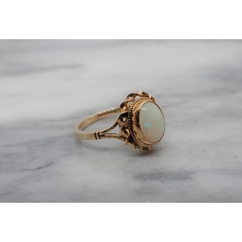 175 - An Opal Ring set oval cabochon in 9ct gold, ring size M, approx 2.60gms