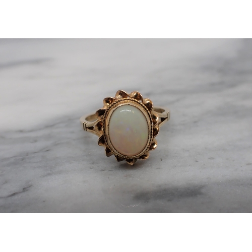 175 - An Opal Ring set oval cabochon in 9ct gold, ring size M, approx 2.60gms