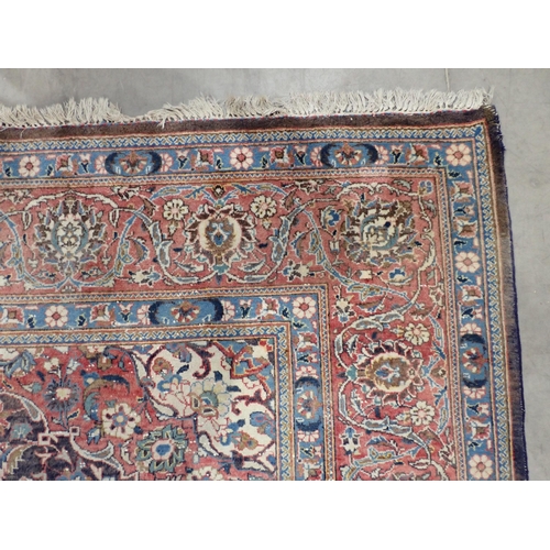 22 - A large Persian multi bordered Rug on red and blue ground with central floral motif 11ft L x 7ft 9in... 