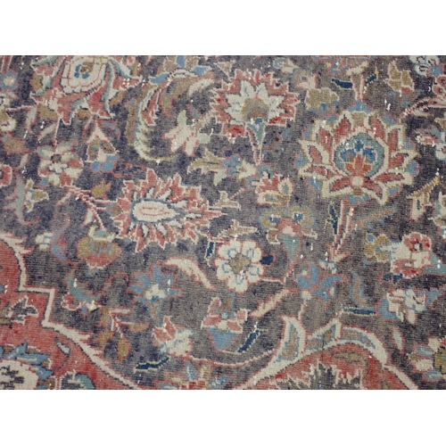 22 - A large Persian multi bordered Rug on red and blue ground with central floral motif 11ft L x 7ft 9in... 