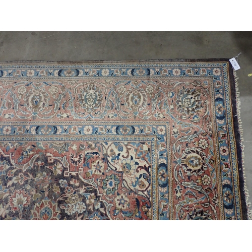 22 - A large Persian multi bordered Rug on red and blue ground with central floral motif 11ft L x 7ft 9in... 