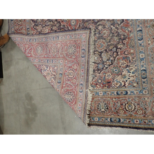 22 - A large Persian multi bordered Rug on red and blue ground with central floral motif 11ft L x 7ft 9in... 