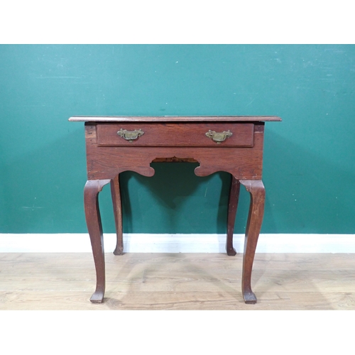 29 - An antique oak Lowboy with single fitted drawer above shaped frieze, carved cupids bow ends, on cabr... 