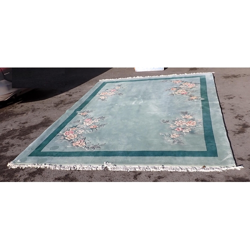 40 - A large modern Chinese Carpet on light blue ground with floral decorations.