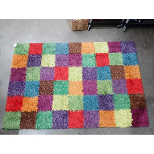 42 - A modern multi coloured square design shag pile Rug, 7ft10