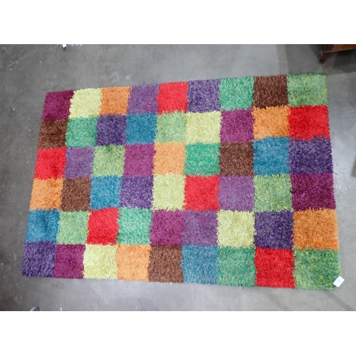 42 - A modern multi coloured square design shag pile Rug, 7ft10