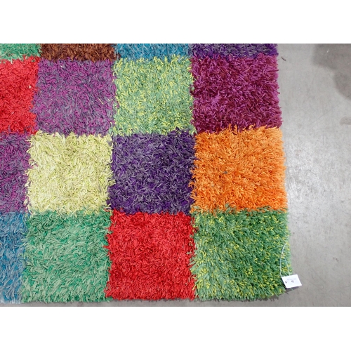 42 - A modern multi coloured square design shag pile Rug, 7ft10